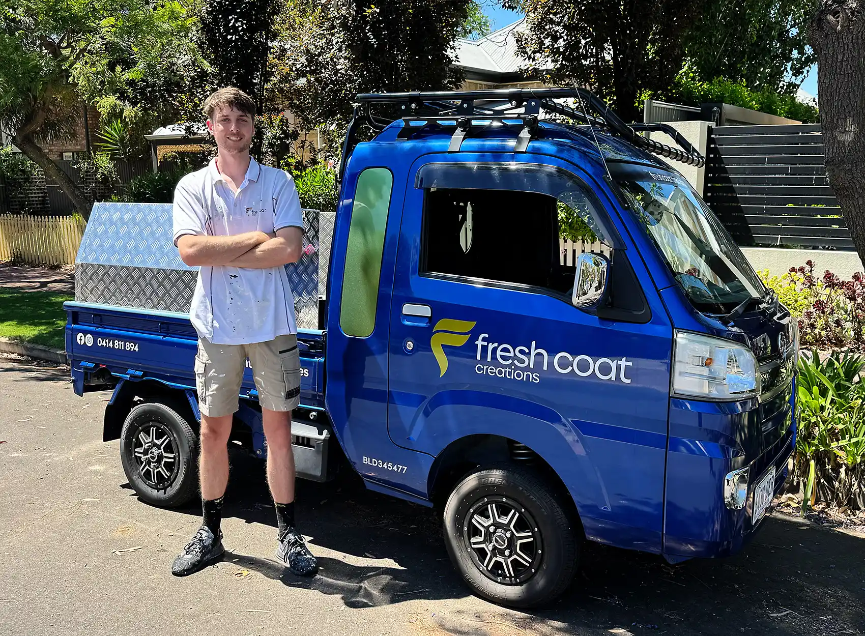 Clay in front of blue fresh coat creations truck
